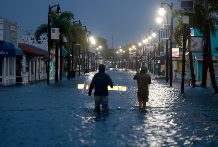 Reporters making their way through streets clsoed by flooding in Tarpon Springs.