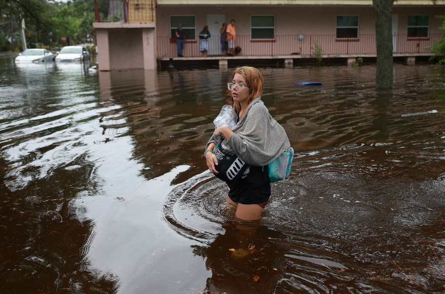 Makatla Ritchter wading through flood waters in Tarpon Springs, Florida as the state is hit by Hurricane Idalia on August 30, 2023.