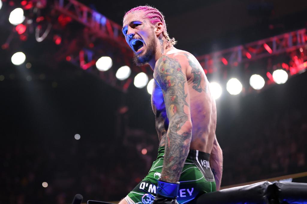 Sean O'Malley celebrates his victory at UFC 292 to become the bantamweight champion.