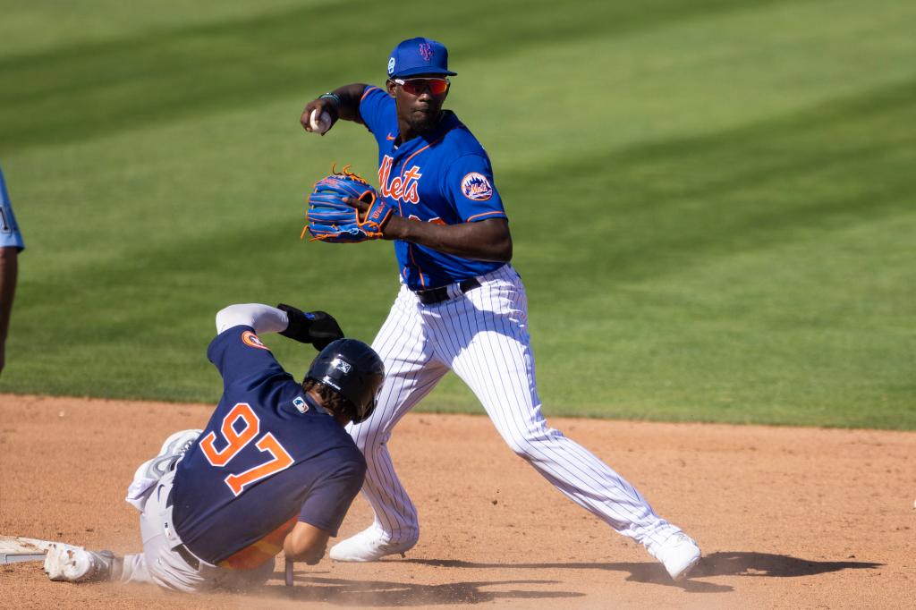 Mets infielder Ronny Mauricio tries to turn a double play during a spring training game.