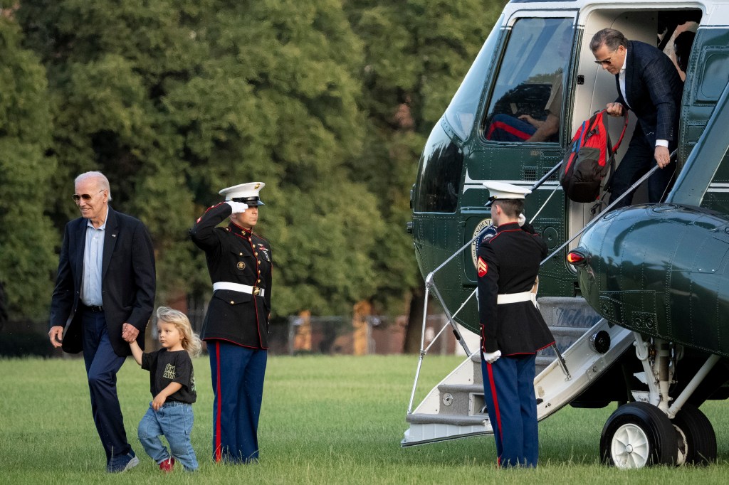 Hunter Biden leaves Marine One while his father President Joe Biden holds the hand of Beau, his youngest grandchild.