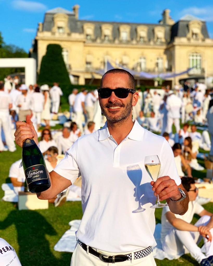 Kris Green holding a bottle of champagne.