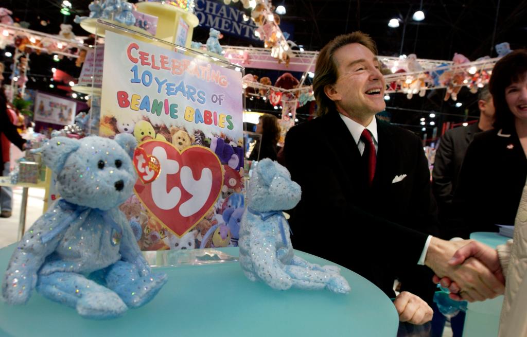 Warner at the American International Toy Fair in 2003 shaking hands.