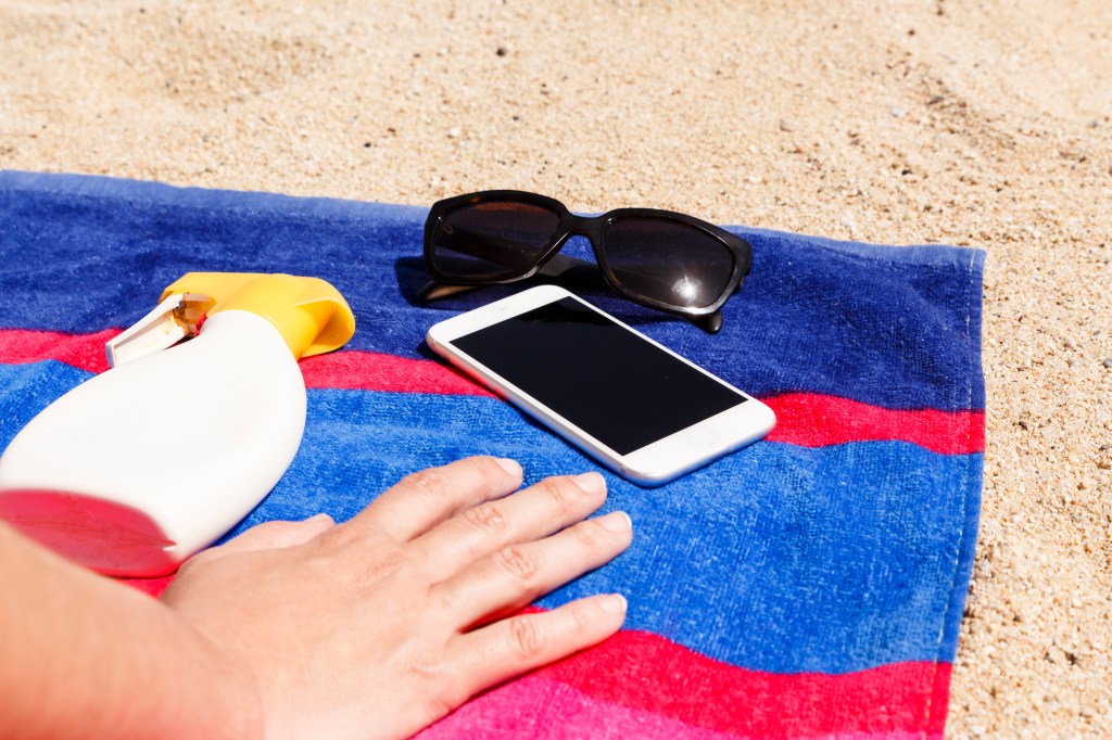 Phone on towel at the beach