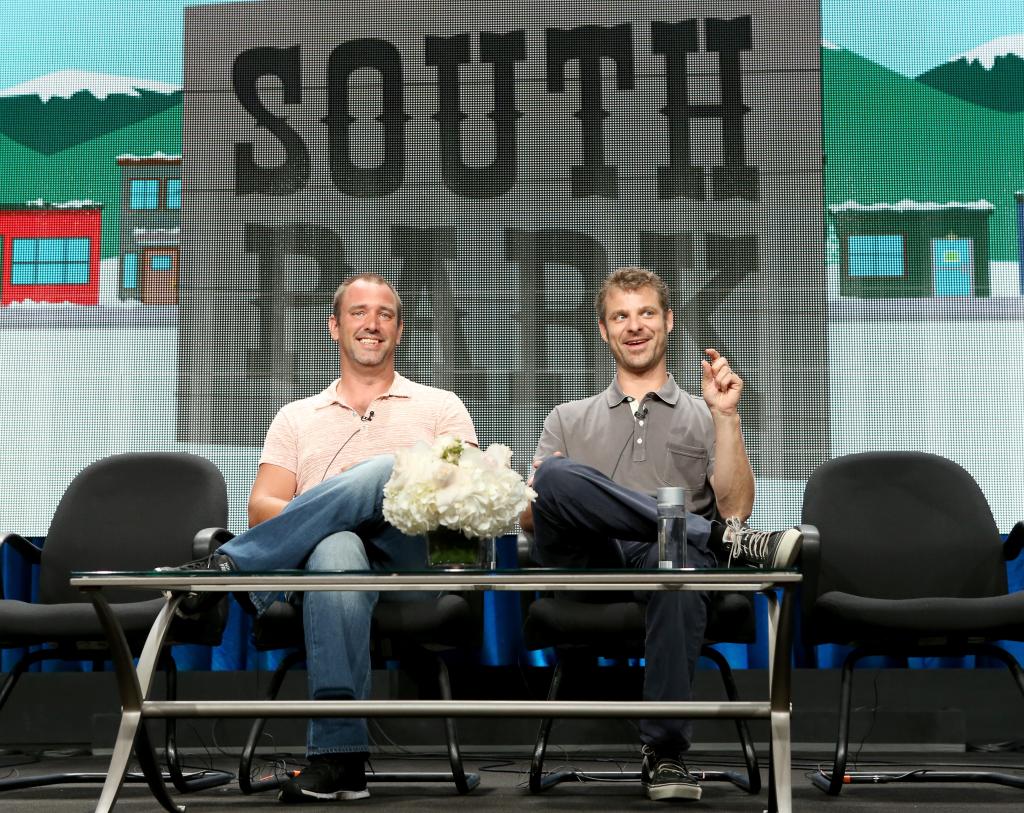 Trey Parker (left) and Matt Stone (right) speak in front of a "South Park" scene.