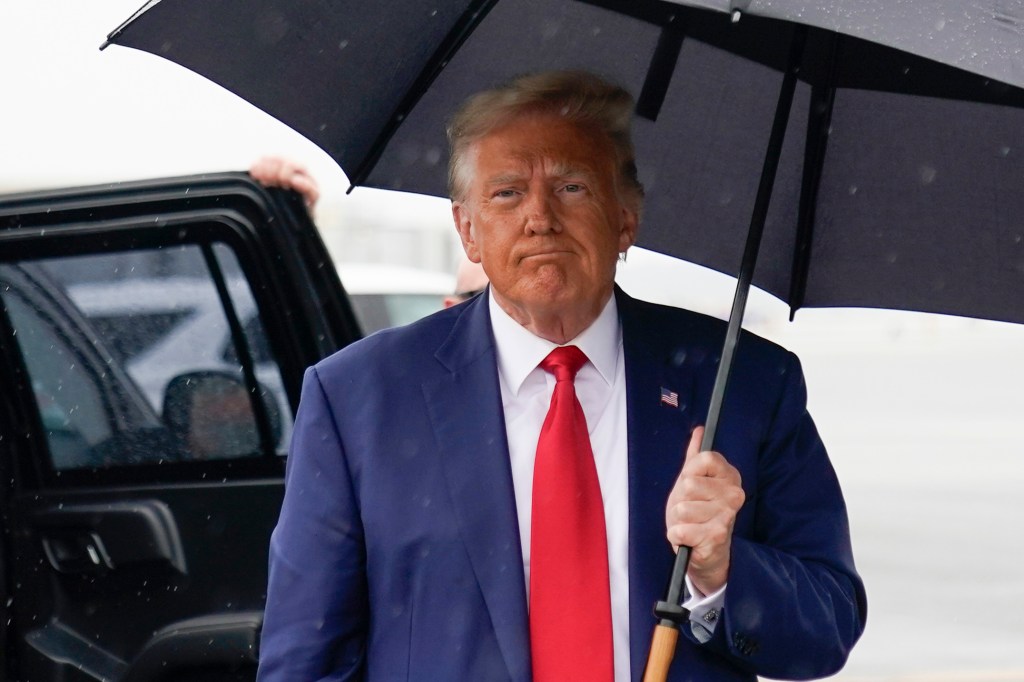 Former President Donald Trump boarding his plan after getting arraigned on federal charges related to his alleged attempts to overturn the 2020 election on August 3, 2023.