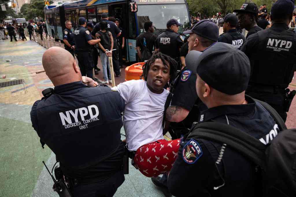 NYPD officers detaining a man at Union Square.