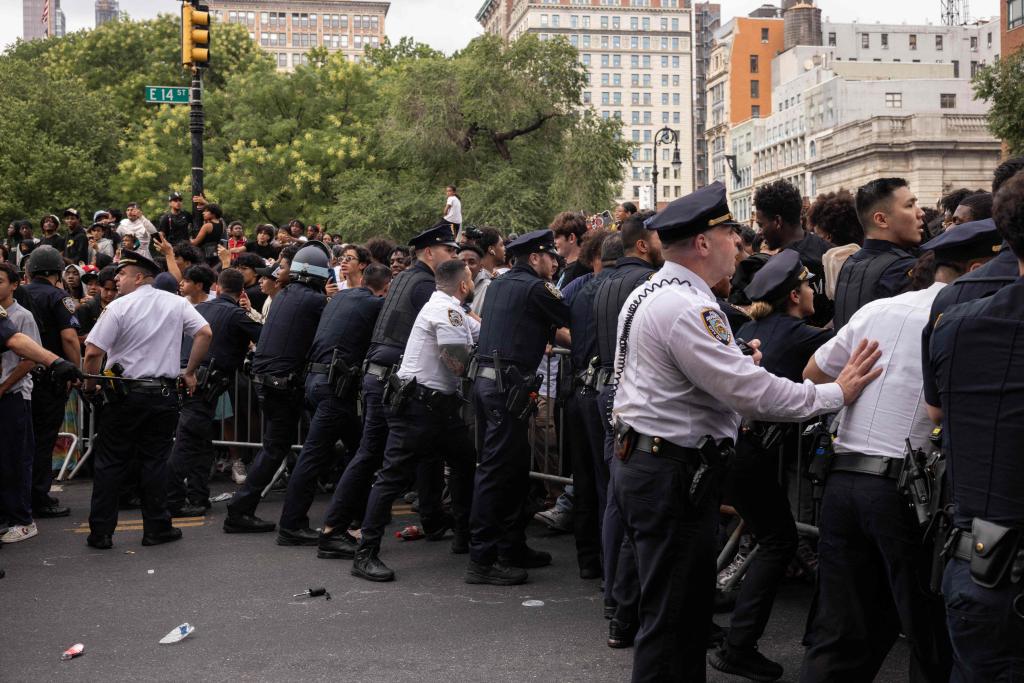 Police attempting to control the crowd at the riot.