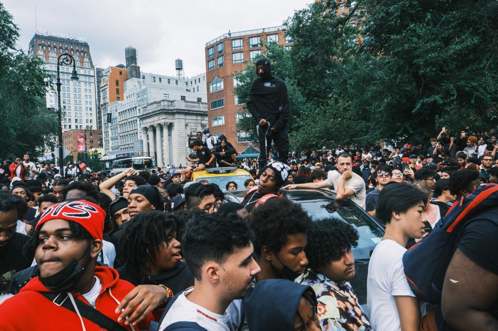 People standing on cars during the chaotic event at Union Square.