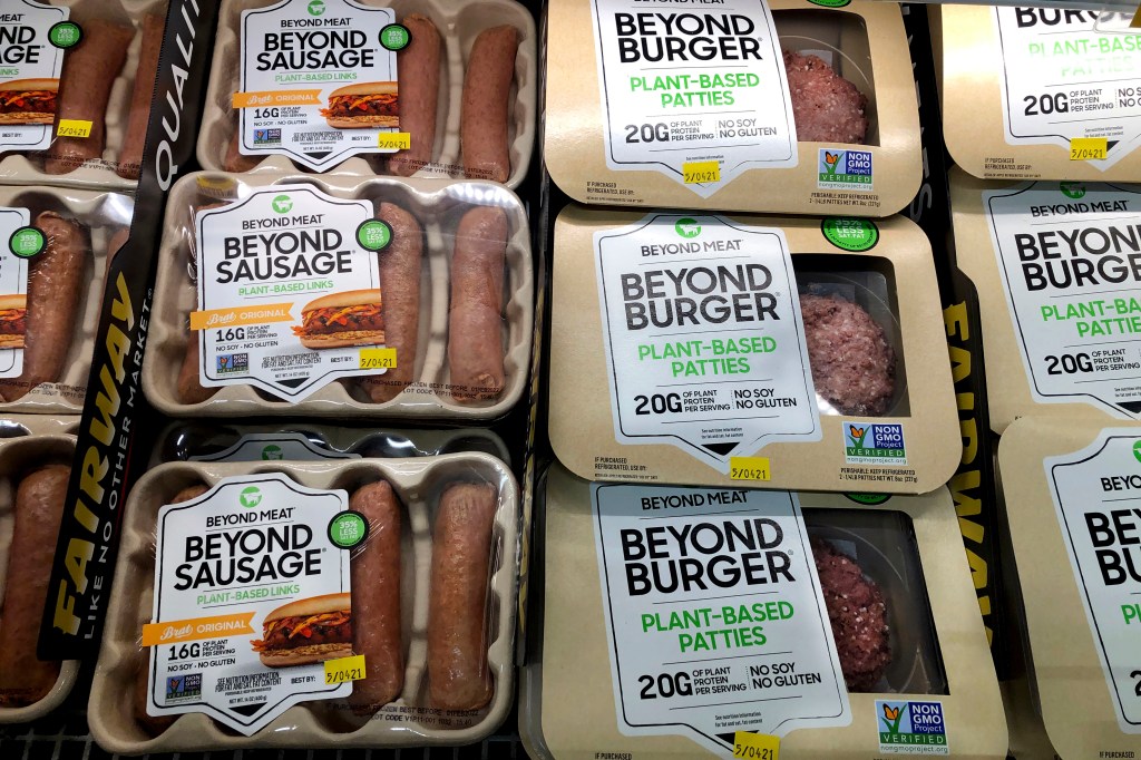 Packages of Beyond Burgers and Beyond Sausages in a supermarket case.