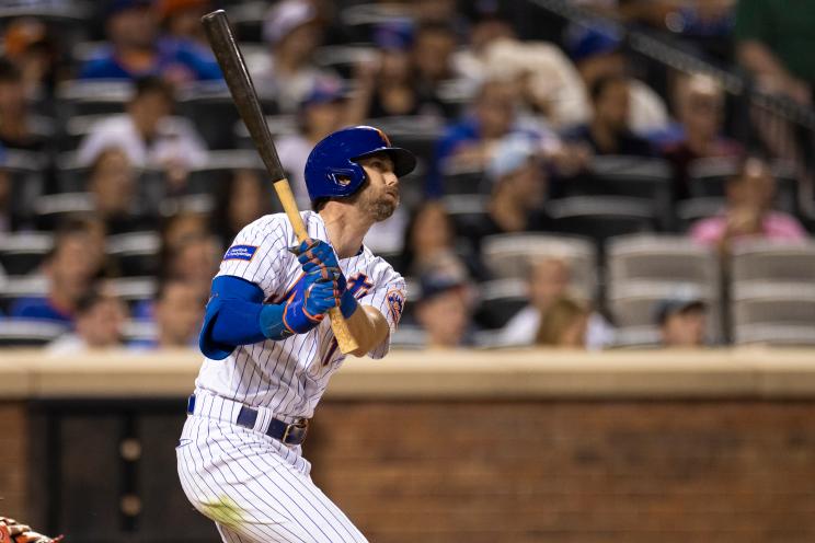 The Mets' Jeff McNeil follows through on a home run.