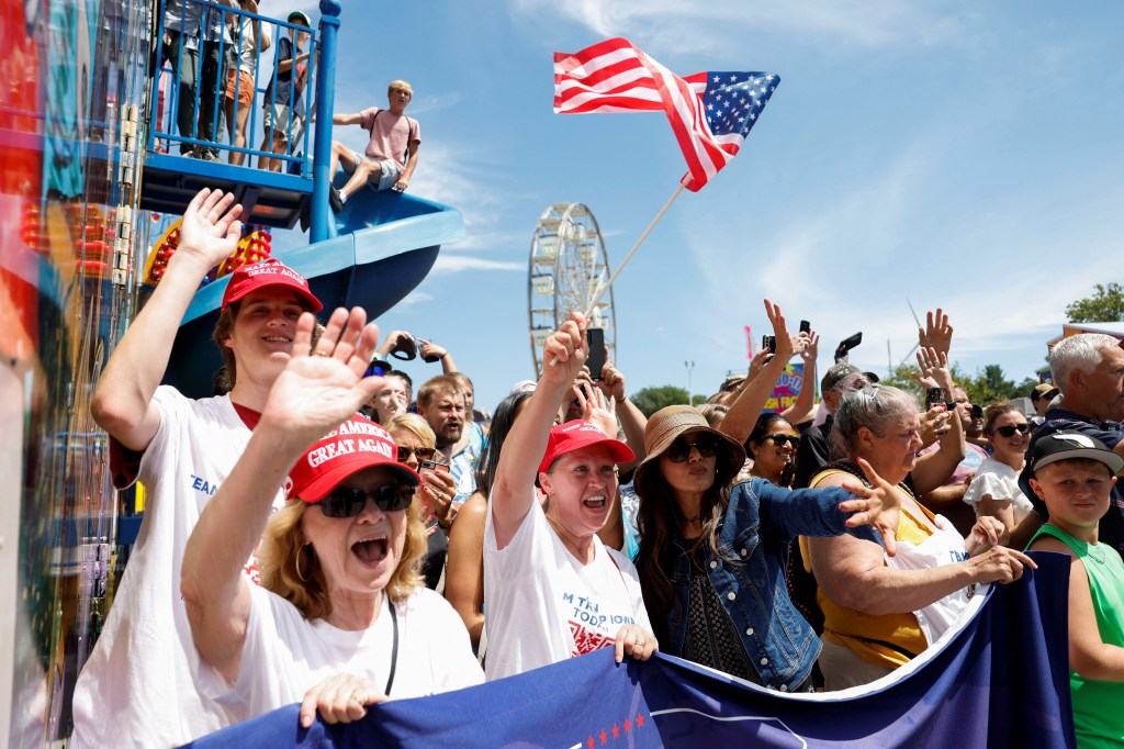 Supporters of Republican presidential candidate and former U.S. President Donald Trump gesture as he campaigns at the Iowa State Fair in Des Moines, Iowa, U.S. August 12, 2023.