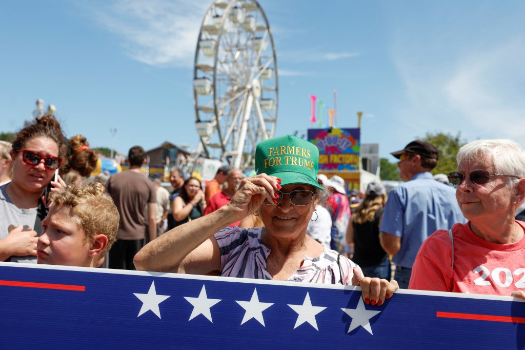 Supporters of Republican presidential candidate and former U.S. President Donald Trump gesture as he campaigns at the Iowa State Fair in Des Moines, Iowa, U.S. August 12, 2023.