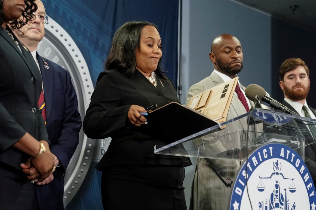 Fulton County District Attorney Fani Willis arrives at a press conference after a Grand Jury brought back indictments against former president Donald Trump and his allies in their attempt to overturn the state's 2020 election results.