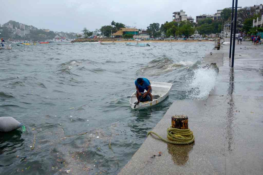 man in a boat is pictured in the flooded Mexican town of Santa Rosalia