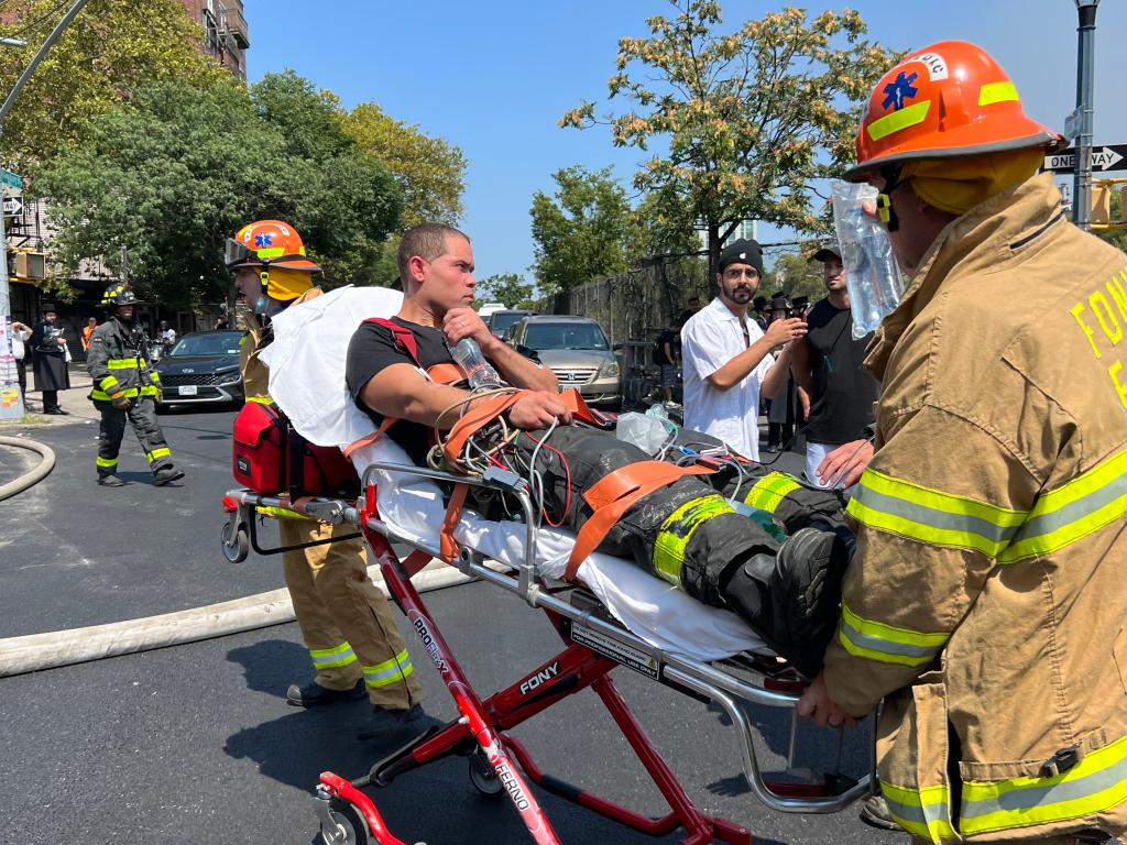 An injured firefighter getting removed from the scene of the fire.