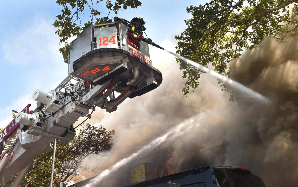 FDNY firefighter working to put out the Lee Avenue blaze.