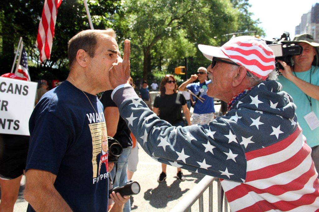 Pro- and anti-migrant protestors are seen clashing outside Gracie Mansion Sunday afternoon.