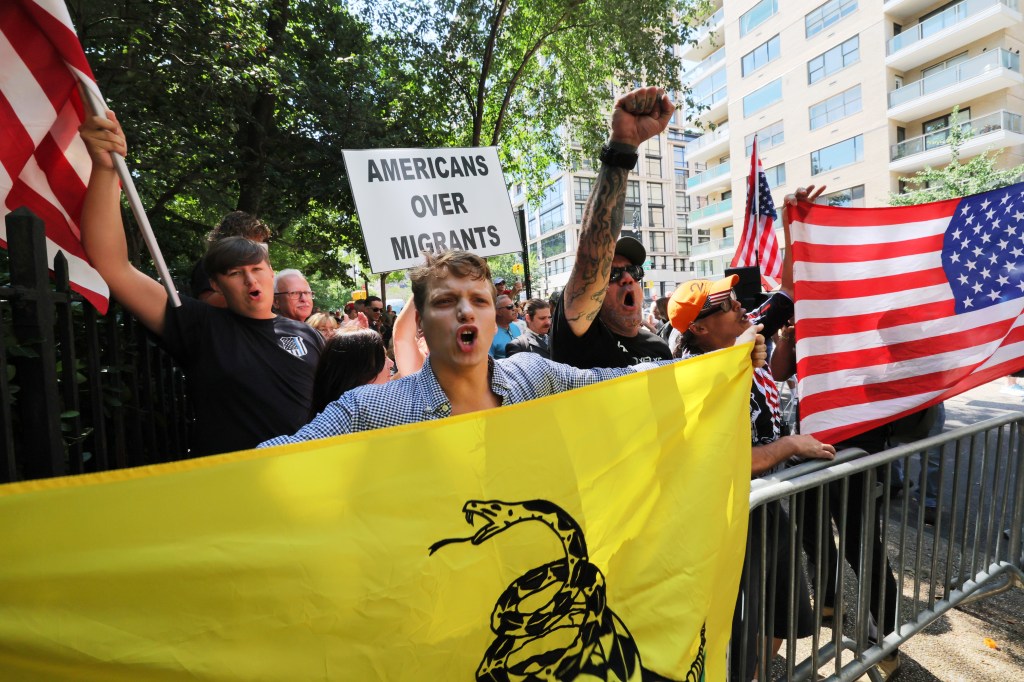 People shout at counterprotestors as they participate in an anti-migrant rally and protest outside of Gracie Mansion on Sunday.