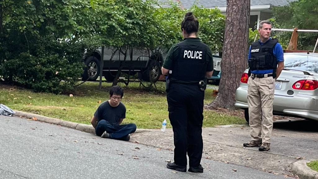 Police with a person of interest on the UNC Campus.