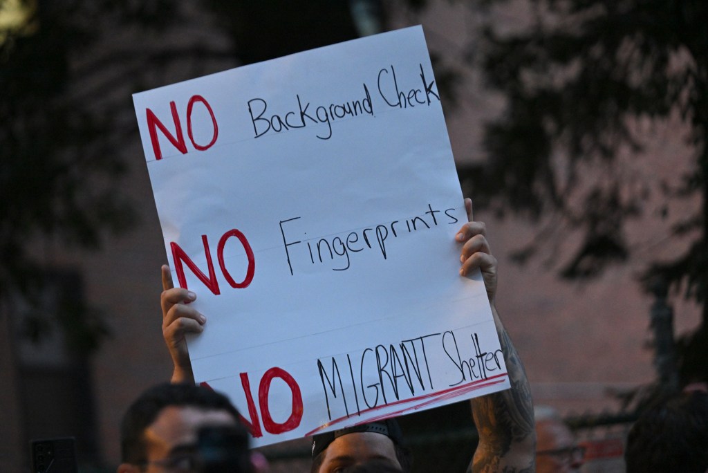 A sign at the rally calling for migrant shelter to not be put on Staten Island.