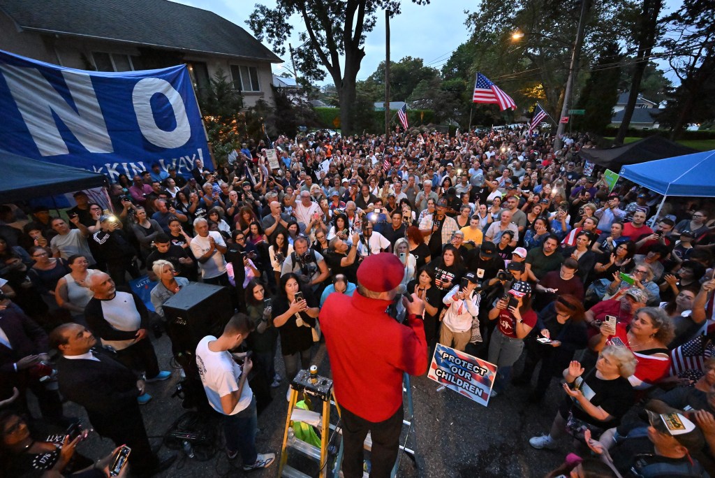 A crowd of people protesting the creation of a migrant shelter at former Catholic school St. John Villa Academy in Staten Island on August 28, 2023.