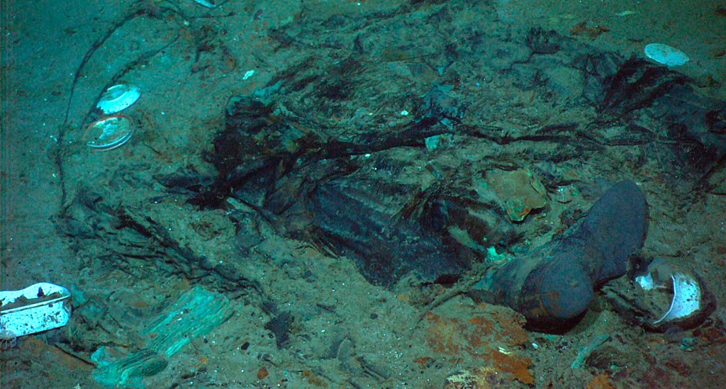 Remains of a coat and boots in the mud on the sea bed lay near the Titanic's stern.