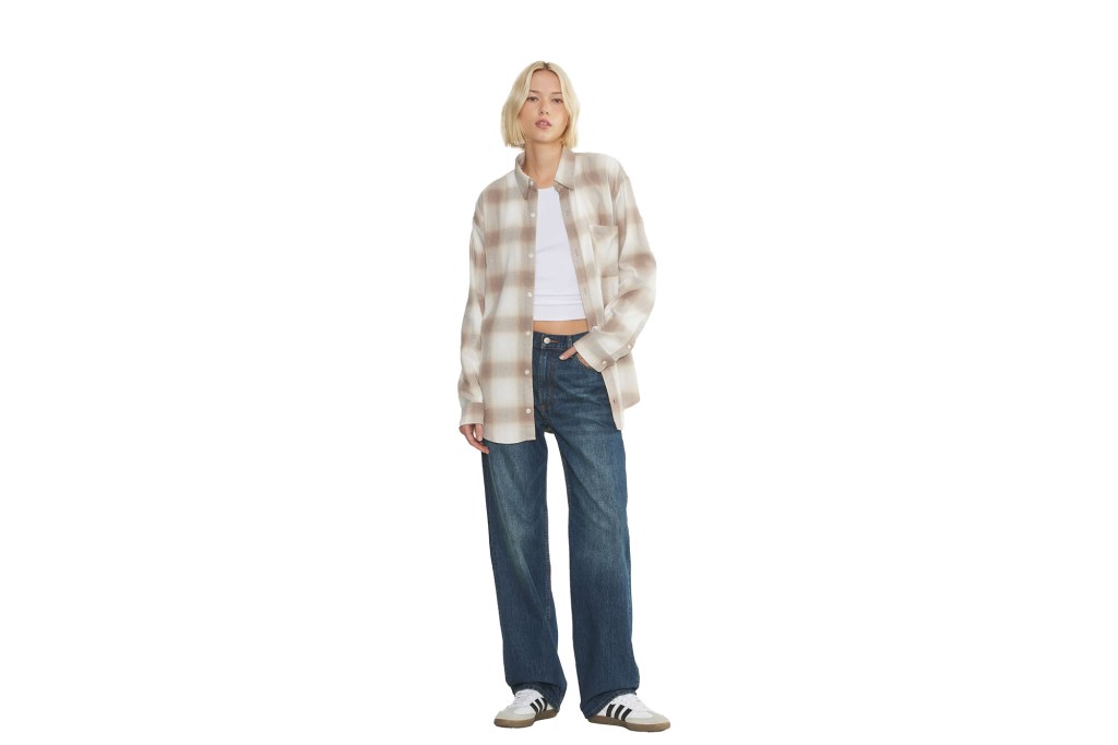 woman standing in a plaid shirt 