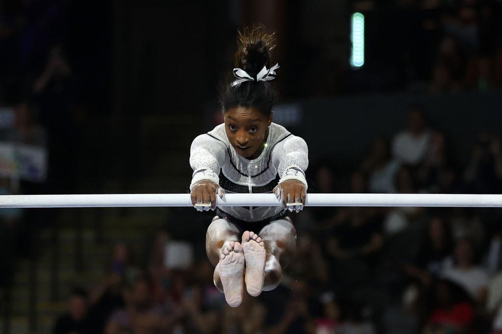 Simone Biles competes in the uneven bars during the Core Hydration Classic at Now Arena on August 05, 2023 in Hoffman Estates, Illinois.