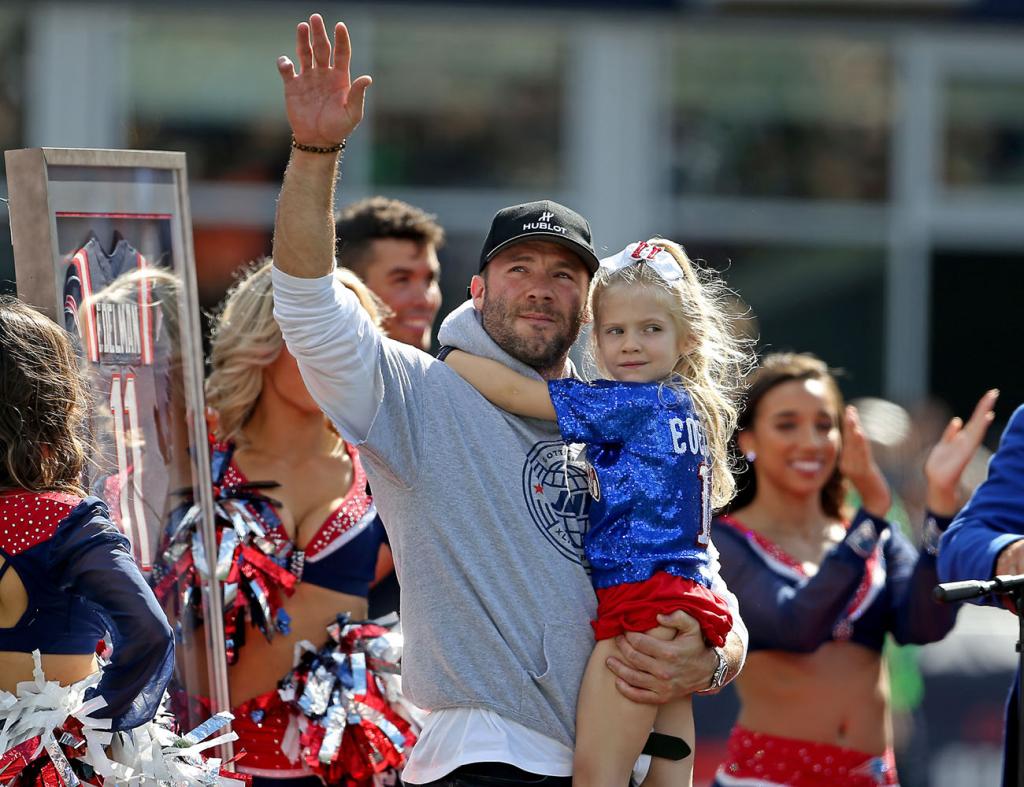 Former New England Patriot, Julian Edelman holds his daughter Lily Rose as he acknowledges the cheering fans at half time of the NFL game against the New Orleans Saints at Gillette Stadium on September 26, 2021 in Foxboro, Massachusetts.   