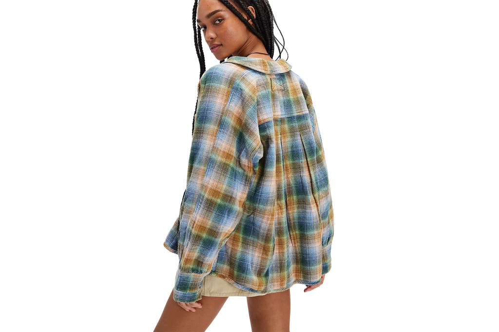 A woman wearing a colorful flannel shirt