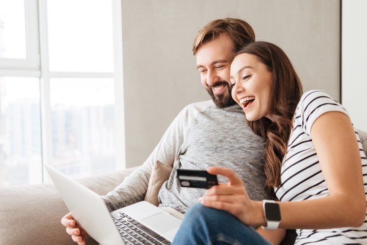 A couple holds one of their credit cards