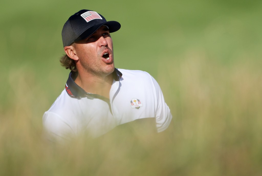 Brooks Koepka shouts fore after playing a shot out of the bunker on the 11th hole in Saturday mornings foursome play at the Ryder Cup.
