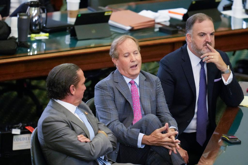 Suspended Texas attorney general KEN PAXTON sits between attorneys TONY BUZBEE, l, and MITCH LITTLE, r, during the morning on day nine as both sides have rested in Texas Attorney General Ken Paxton's impeachment trial in the Texas Senate on September 15, 2023. 