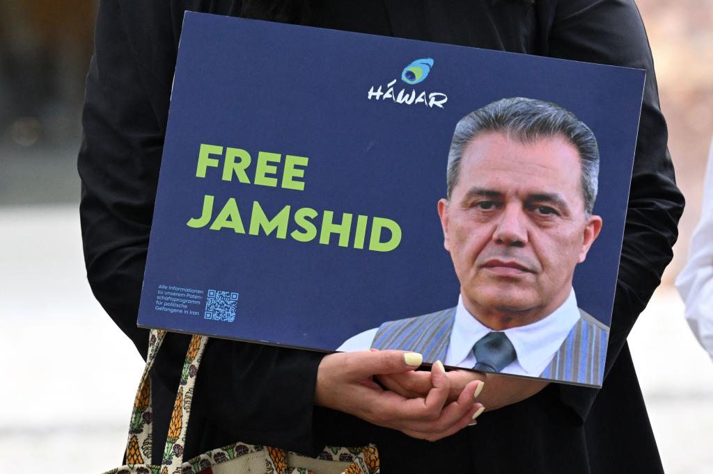 A demonstrator holds a picture of Iranian-German Jamshid Sharmahd.