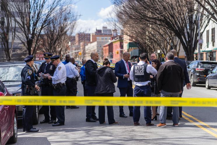 Police investigate the scene where the 16-year-old girl was shot and killed.