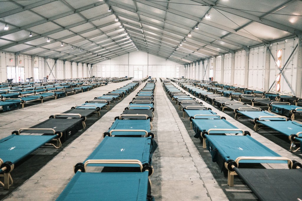 Image of cots in migrant shelter.