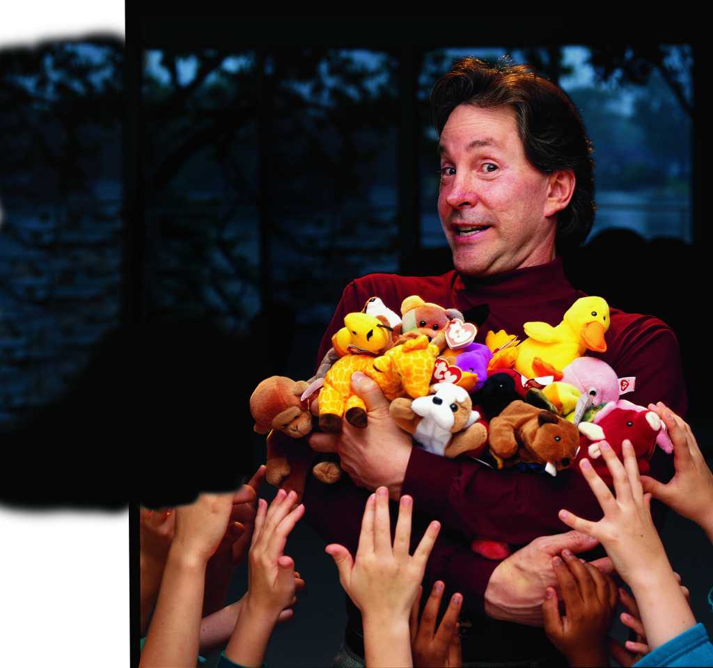 Ty Warner holding a bunch of Beanie Babies