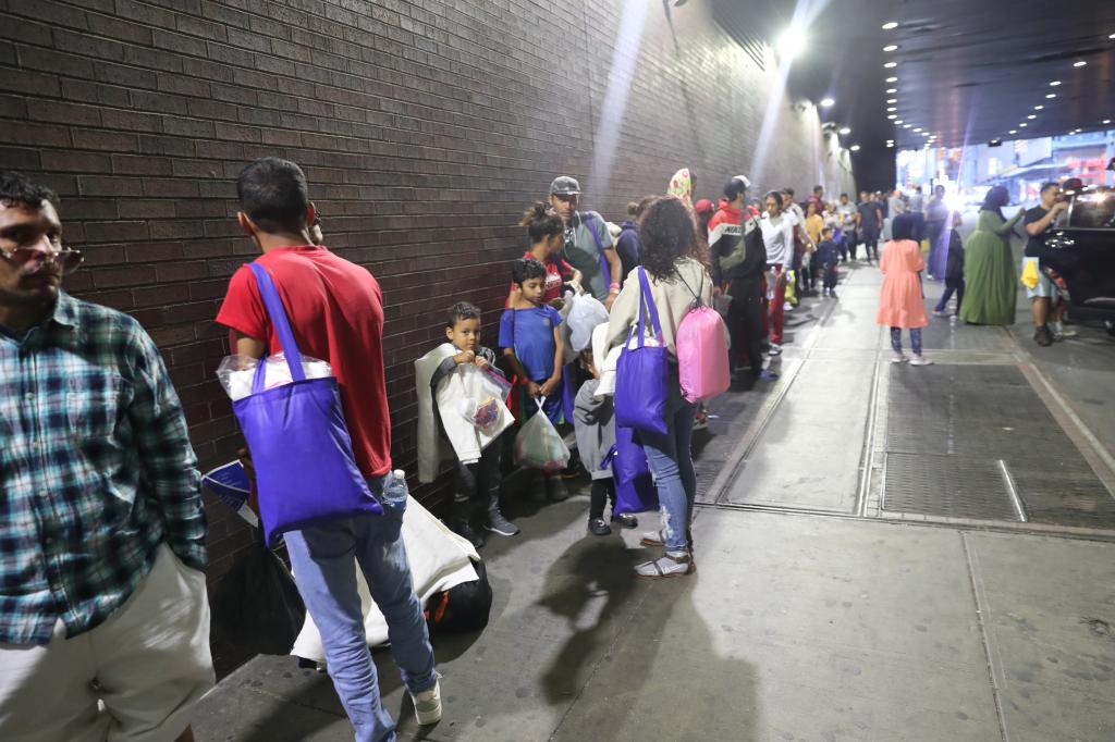 Migrant families lined up outside Port Authority in Manhattan.