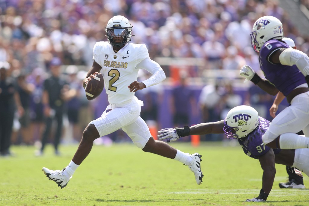 Buffaloes quarterback Shedeur Sanders (2) scrambles out of the pocket