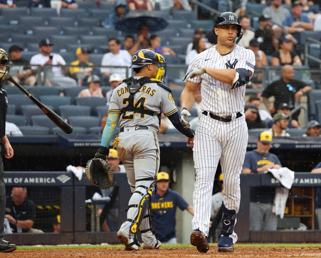 Giancarlo Stanton tosses his bat after he strikes out swinging during the fifth inning against the Milwaukee Brewers.