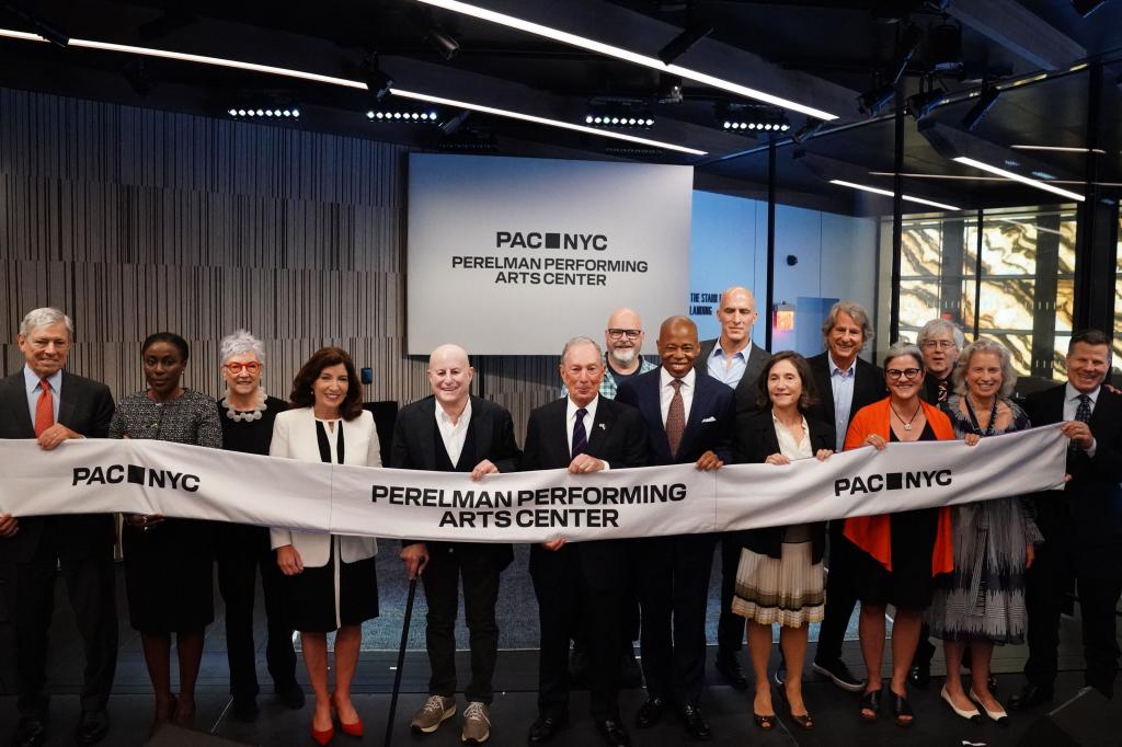 Governor Kathy Hochul (4th L), Ron Perelman (5th L), former Mayor Michael Bloomberg (C) and current Mayor Eric Adams hold a ribbon at the Perelman Performing Arts Center