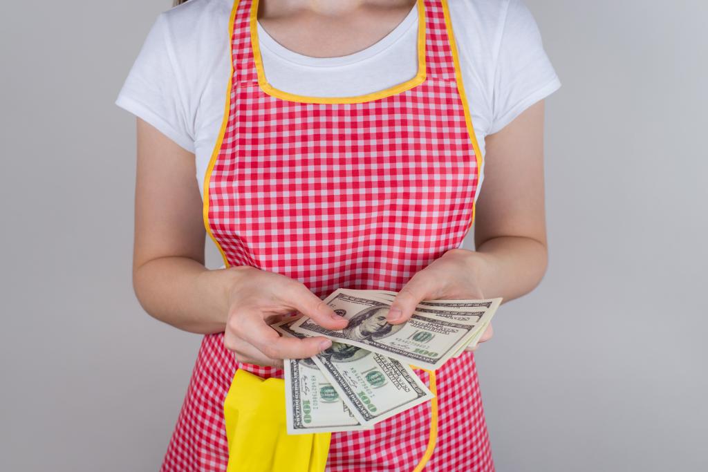 A maid holding money. 