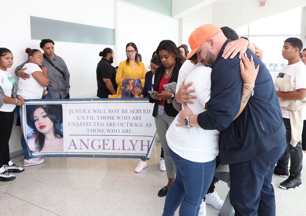 Yanely Henriquez and Manuel Yambo (Angellyh’s father) hugged after hearing the sentencing of Jeremiah Ryan. 
