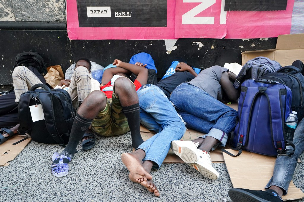 Asylum seekers sleeping on the sidewalk in line, this morning to get into the Roosevelt Hotel.  