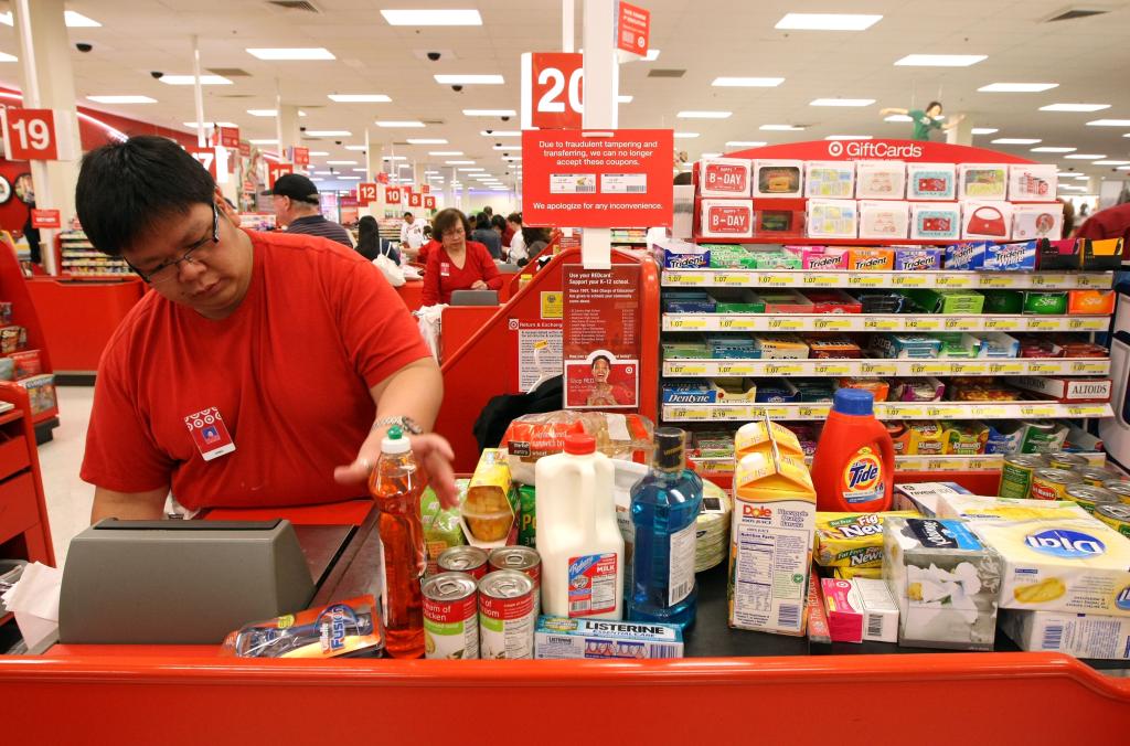 A Target employee scanning items at check-out.