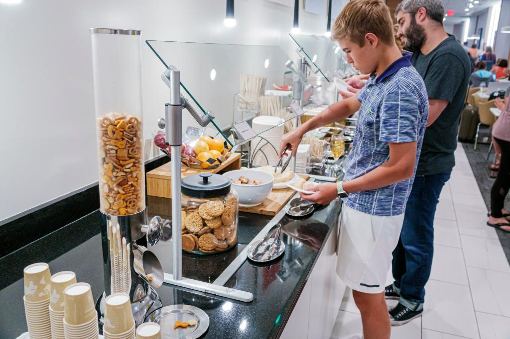 Florida, Fort Lauderdale, Delta Sky Club, passenger lounge, complimentary snacks buffet. 