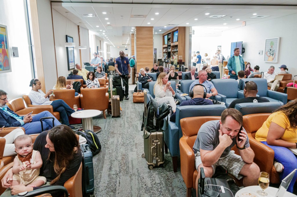 Florida, Fort Lauderdale, Delta Sky Club, busy crowded passenger lounge.