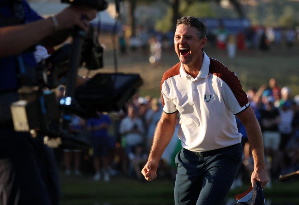 Team Europe's Justin Rose celebrates after holing his putt on the 16th hole to win their match.