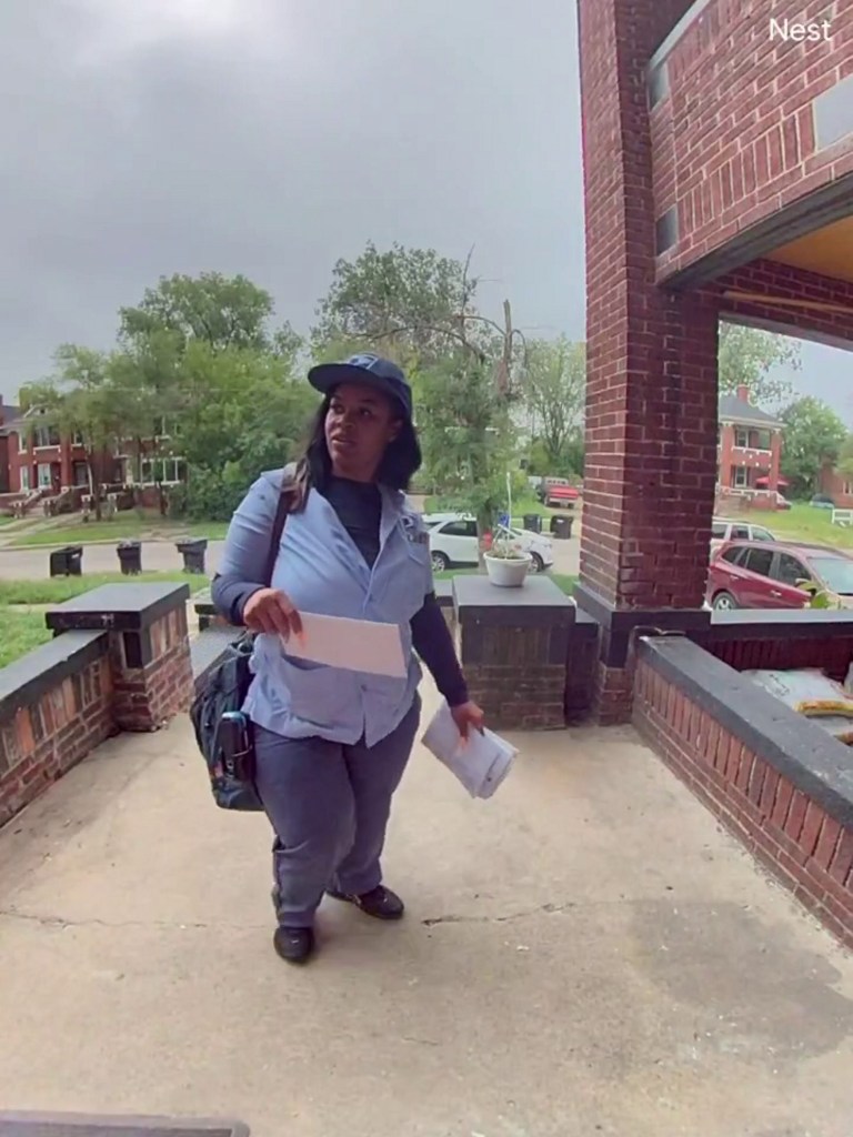 Postal worker Benethia Williams reacts to the new, pink door.